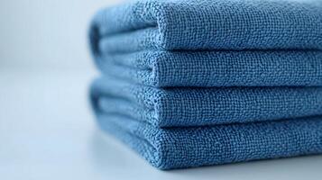 Soft blue cotton towels stack neatly folded, showcasing plush luxury bathroom textiles with high-quality fabric texture in pale blue theme, creating spa-like atmosphere against white background. clean photo