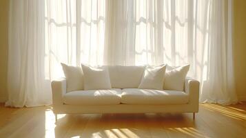 Modern interior displays elegant white sofa with flowing sheer curtains, natural sunlight streaming through windows, creating airy atmosphere in minimalist living space. clean photo