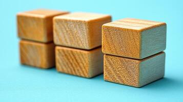 Simple wooden blocks form a playful structure against a blue backdrop photo