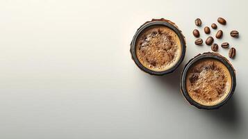 Two rustic cups of coffee beside scattered coffee beans on a smooth surface photo