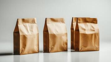 Three neatly sealed paper bags are aligned on a pristine white surface photo