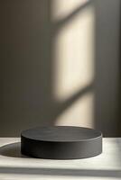 Minimalist matte black ceramic podium on a muted gray background with soft shadows and ample negative space for text in a modern Scandinavian setting photo