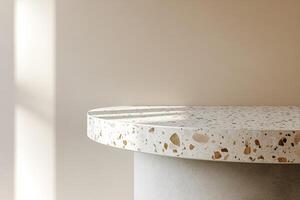 Modern Nordic podium with concrete base and terrazzo top against soft beige background offers clean space for text overlay photo