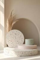 Sleek terrazzo podium displaying natural stone chips in muted pastel colors of blush pink, sage green, and light gray against a soft neutral backdrop in a modern Nordic style photo
