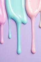 Colorful nail polish drips in pastel shades create a cheerful and playful background for creative projects or beauty content photo