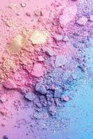 Scattered pastel eyeshadow pigments in shimmering colors on a soft rainbow gradient background offering a magical and playful atmosphere photo