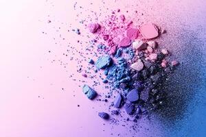 Scattered pastel eyeshadow pigments create a magical and playful atmosphere on a vibrant rainbow gradient background photo