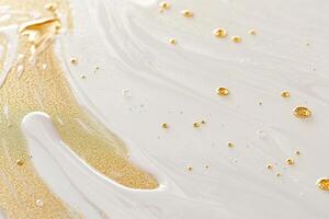 Golden liquid drops create an abstract cosmetic texture on a glossy white surface with soft light reflections for a calming effect photo