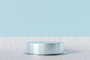 Elegant silver podium on snowy surface with soft blue background, perfect for showcasing products in minimal winter-themed setting. Ideal for holiday campaigns, branding, modern displays. 3D render. photo