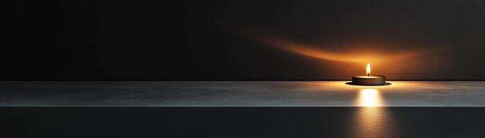 A warm candle flame softly glows in a darkened space, casting gentle reflections and creating a tranquil atmosphere ideal for relaxation or meditation photo