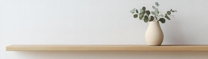 Calming and stylish setup showcases a light oak wooden shelf adorned with a matte ceramic vase in soft beige, holding a sprig of eucalyptus against a light backdrop photo
