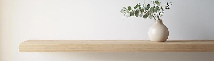 Showcasing a sleek light oak shelf adorned with a matte beige ceramic vase, this serene setup features a sprig of eucalyptus against a light wall, perfect for modern decor photo
