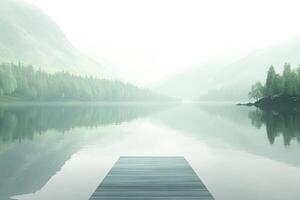 Experience the peaceful ambiance of a minimalist Nordic mountain lake, where a small wooden dock stretches into still waters surrounded by soft gray mountains and muted green forests photo