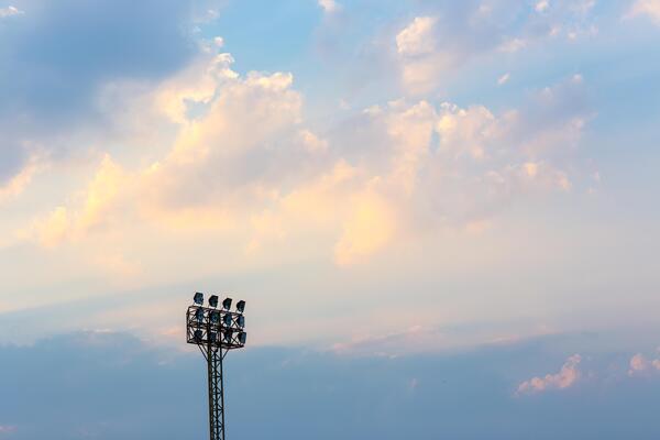 Spotlight of football stadium is lighting up beautiful background cloud