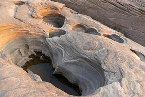 A rock eroded by water into a hole on the banks of the Mekong River.Sam Phan Boke, Ubon Ratchathani Thailand photo