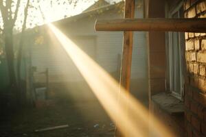 Sunlight streams through a gap illuminating the exterior of a rustic building in early morning light with soft shadows photo