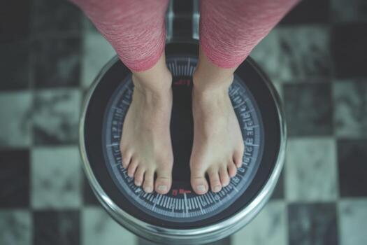 A person standing on a scale with their feet on it photo