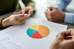 Business people holding papers with pie chart on top photo