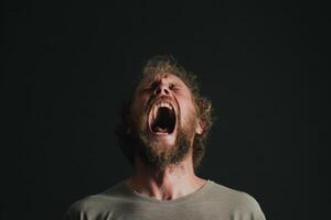 A man with a beard and beard is screaming photo