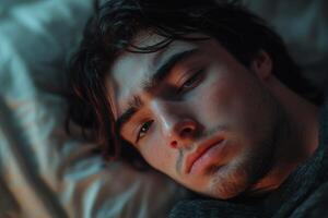 A man laying in bed with his eyes closed photo