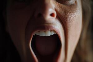 A woman with her mouth open and her teeth showing photo