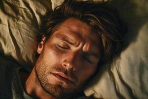 A man sleeping in bed with his eyes closed photo