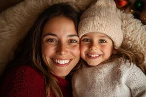 Smiling mother and daughter share a joyful moment together during festive celebrations in a cozy indoor setting photo