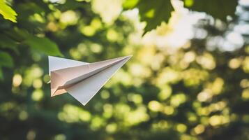 A white paper airplane flying the air photo