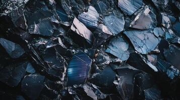 Black rocky surface with reflections. photo