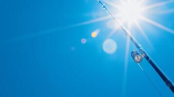 Sparkling Fishing Rod Against Bright Blue Sky Background photo