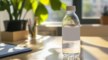 Plain water bottle with blank label on office desk horizontal photo