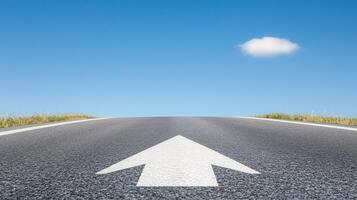 Road to Success Concept with Wide Asphalt Road and Distinctive Painted Arrow Sign Under Clear Blue Sky for Inspirational Journey and Forward Movement in Landscape Photography photo