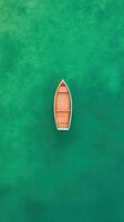 Aerial View of Wooden Boat Moving Over Vibrant Green Sea Capturing Tranquility and Clear Water from Above photo