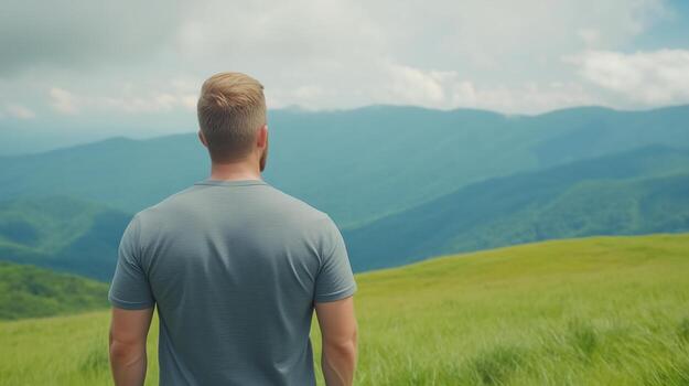 Man Walking in Mountain Landscape with Rack Focus Effect Showcasing Breathtaking Green Hills and Cloudy Sky photo