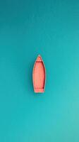 Vertical Shot of a Wooden Boat in Calm Turquoise Water Capturing Serene Aesthetic Ideal for Travel Themes and Water-Themed Designs Highlighting Unique Perspective and Tranquil Atmosphere photo