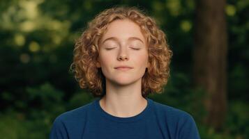 Tranquil Young Woman Meditating Outdoors in Nature with Eyes Closed Practicing Relaxation and Stress Relief Techniques Surrounded by Greenery in Serene Natural Environment for Mindfulness photo