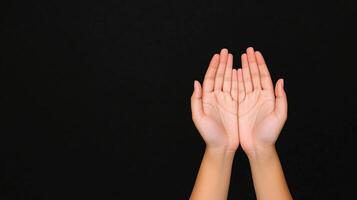 Two Hands in Protective Gesture Against Black Background Highlighting Safety and Security Concept photo