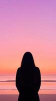 Tranquil Woman Silhouette Watching Sunset Over Calm Beach Horizon with Vibrant Sky and Serene Ocean in Minimalist Style Epic Scene photo