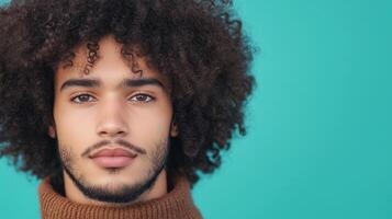 Portrait of Young Man with Curly Hair in Brown Sweater Against Turquoise Background Emphasizing Serenity and Confidence in Modern Stock Photography for Contemporary Design Projects photo
