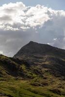 Majestic mountain peak under dramatic clouds photo