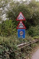 Low bridge height and weight restriction warning road signs photo