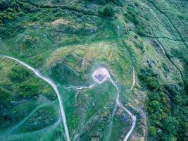 Drone showing winding path leading to summit with tourists hiking photo