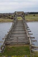Old wooden bridge crossing a river in Great Britain photo