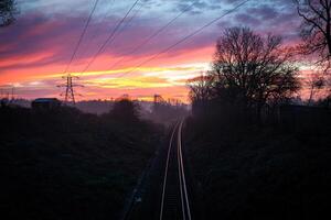 Plymouth Railway Disappearing into Colorful Sunrise in Plymouth, United Kingdom photo