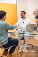 Dentist shaking hands with patient after successful visit in clinic photo