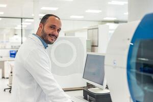 Scientist working with computer and modern equipment in laboratory photo