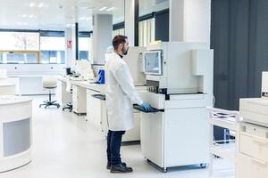 Scientist working with modern automated equipment in laboratory photo