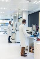Scientists working with advanced equipment in modern bio laboratory photo