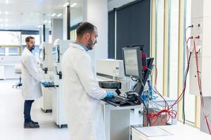 Scientists working with advanced equipment in a modern laboratory photo