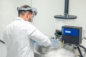 Scientist working with liquid nitrogen tank in a bio laboratory photo